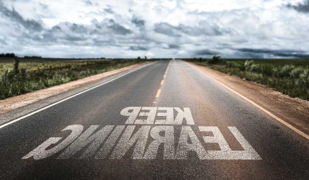 Picture of open road with the phrase keep learning 